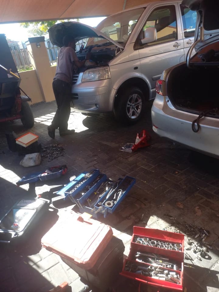 Mechanic servicing a van at a customer's home