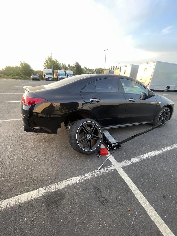 Mobile wheel replacement on a Mercedes in a parking lot